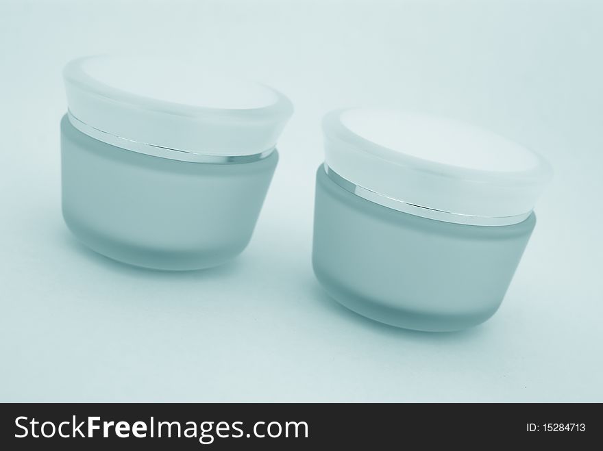 Two containers of cosmetic face cream close-up. Two containers of cosmetic face cream close-up