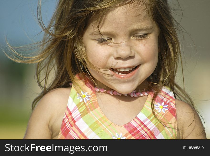 A little girl running in a field on windy day. A little girl running in a field on windy day