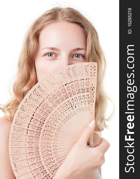 Beautiful young woman with a fan on a white background