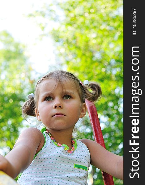 Thinking little girl in the green park. Thinking little girl in the green park