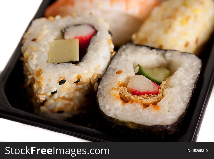 Delicious sushi mix against a white background