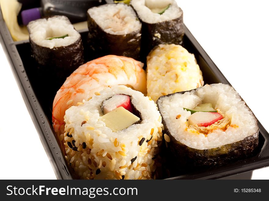 Delicious sushi mix against a white background