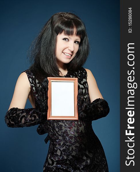 The beautiful girl in  black dress with  framework for  photo