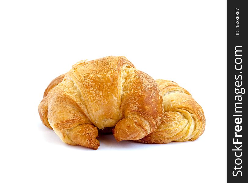 Golden croissant on white background