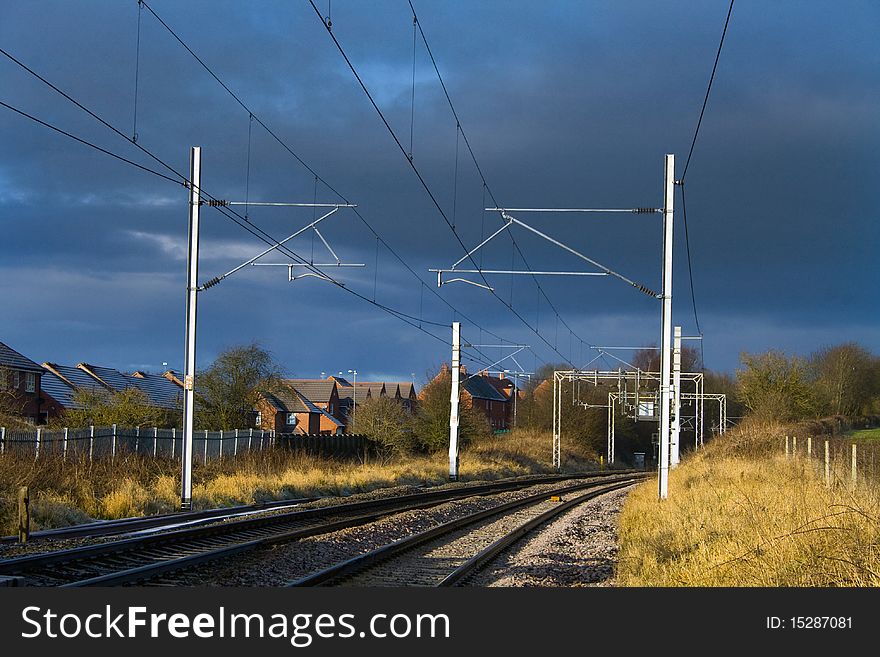 Stormy weather approaching along a railway line