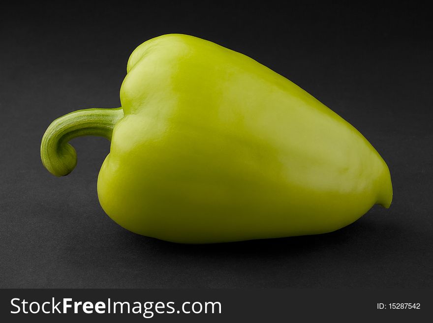 Green bell pepper on a black background