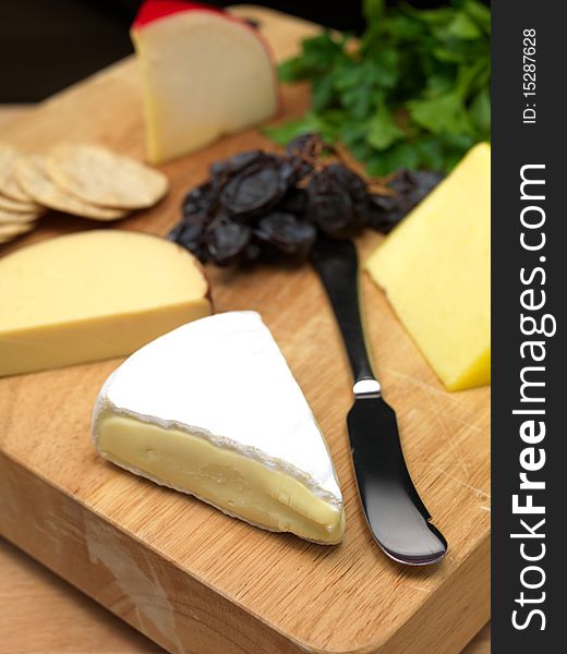 A selection of cheeses on a cutting board. A selection of cheeses on a cutting board