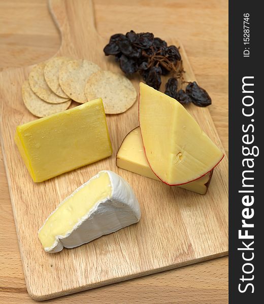 A selection of cheeses on a cutting board. A selection of cheeses on a cutting board