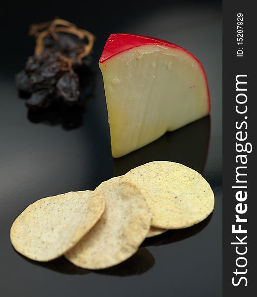 Gouda cheese isolated on against a black background