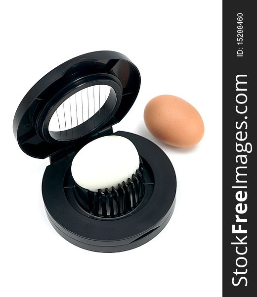 An egg slicer isolated against a white background