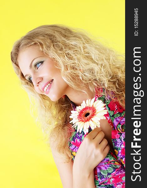 Beautiful girl and gerbera on a light background