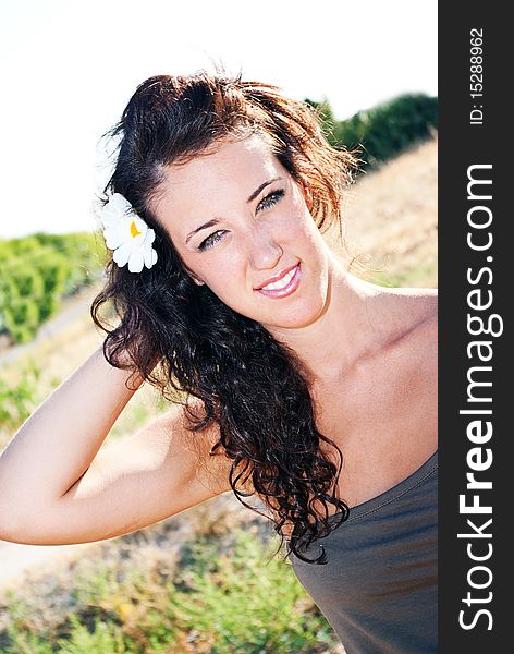 Sensual young girl with light skin and dark hair posing on white background