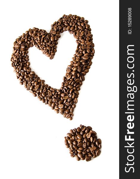 Coffee grains lying in the shape of the heart or exclamation mark