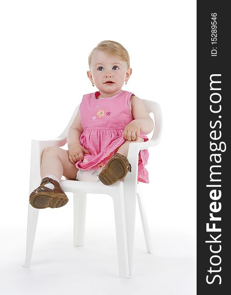 Infant on stool on white background.