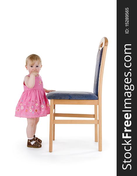 Infant with chair on white background.