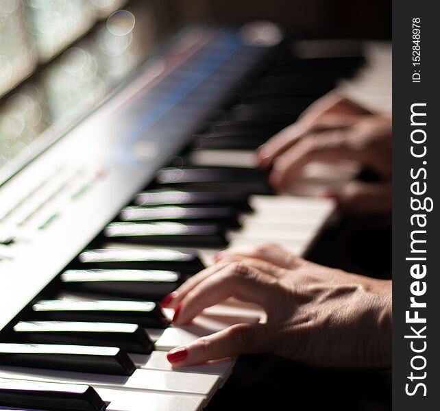 A beautiful scene of a woman playing music with a beautiful casio keyboard. A beautiful scene of a woman playing music with a beautiful casio keyboard.