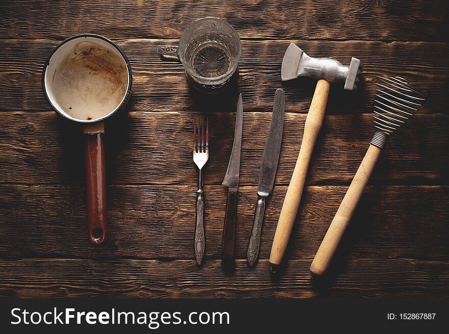 Old kitchen utensils on a rural kitchen table background, dishes, accessories, hammer, cutlery, vintage, retro, wooden, rustic, simple, ladle, knife, fork, glass, cup, top, view, above, flat, flatlay, kitchenware, equipment, tools, shaker, beater, mallet, food, cook, cooking, set, collection. Old kitchen utensils on a rural kitchen table background, dishes, accessories, hammer, cutlery, vintage, retro, wooden, rustic, simple, ladle, knife, fork, glass, cup, top, view, above, flat, flatlay, kitchenware, equipment, tools, shaker, beater, mallet, food, cook, cooking, set, collection