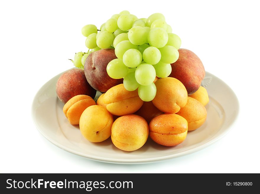 Fruit on a platter, grapes, peaches and apricots