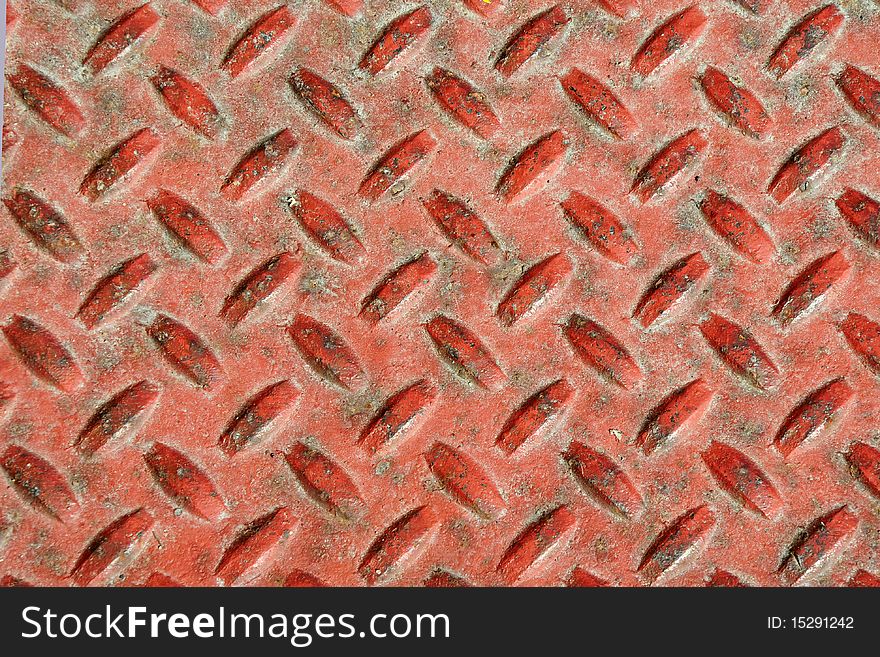 A walking orange and rusty tread in front of a business door. A walking orange and rusty tread in front of a business door.