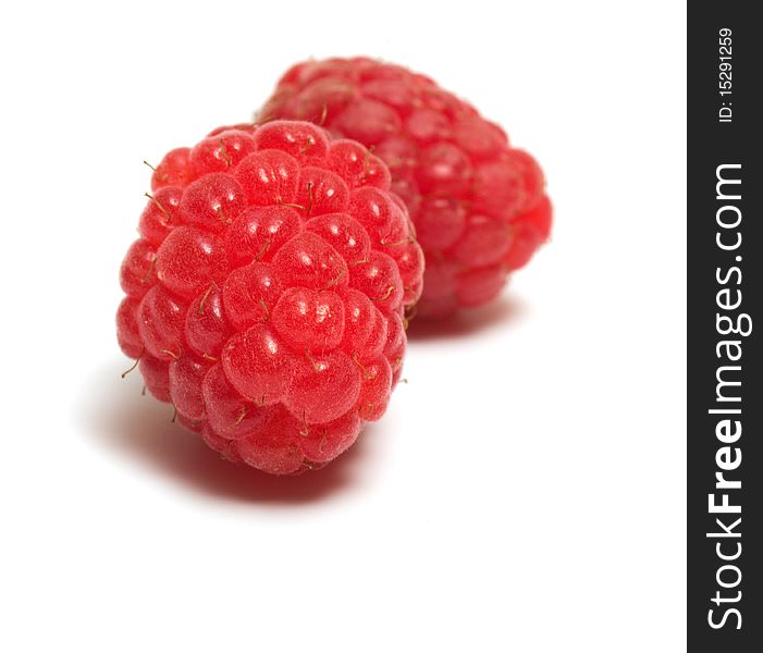 Two berries raspberry closeup isolated on a white background. Two berries raspberry closeup isolated on a white background.
