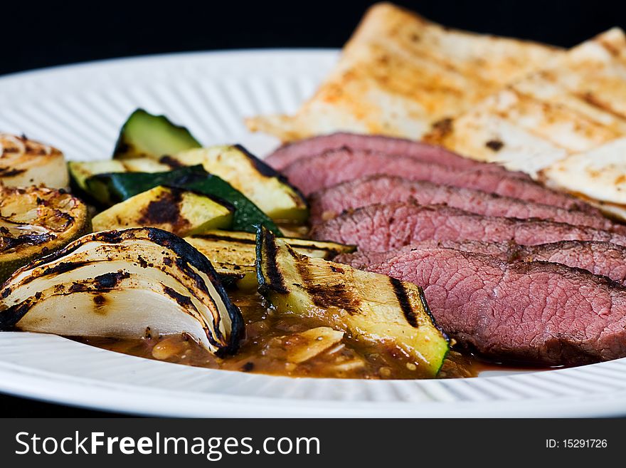 Sliced sirloin with grilled vegetables and tortillas. Sliced sirloin with grilled vegetables and tortillas.