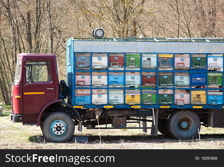 Colorful truck filled with beehives in spring in Romania. Colorful truck filled with beehives in spring in Romania.