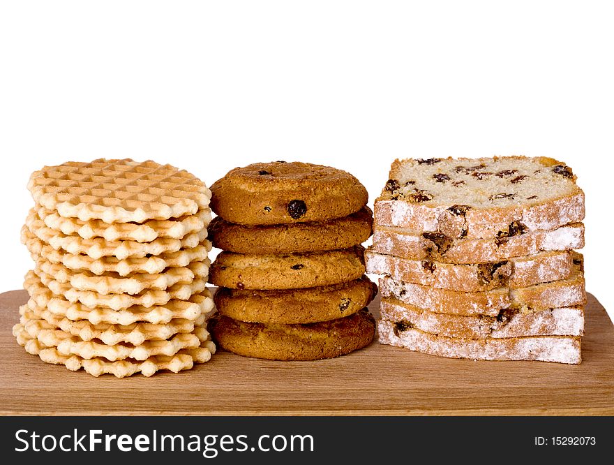 Piles of wafers, oatmeal biscuits and cake