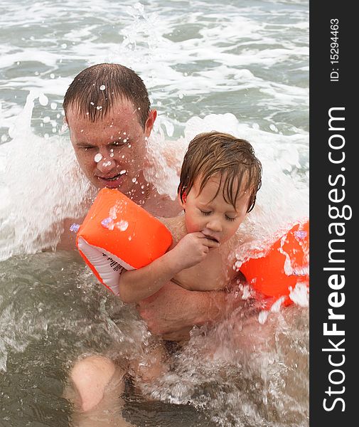 Father and son bathing in the sea