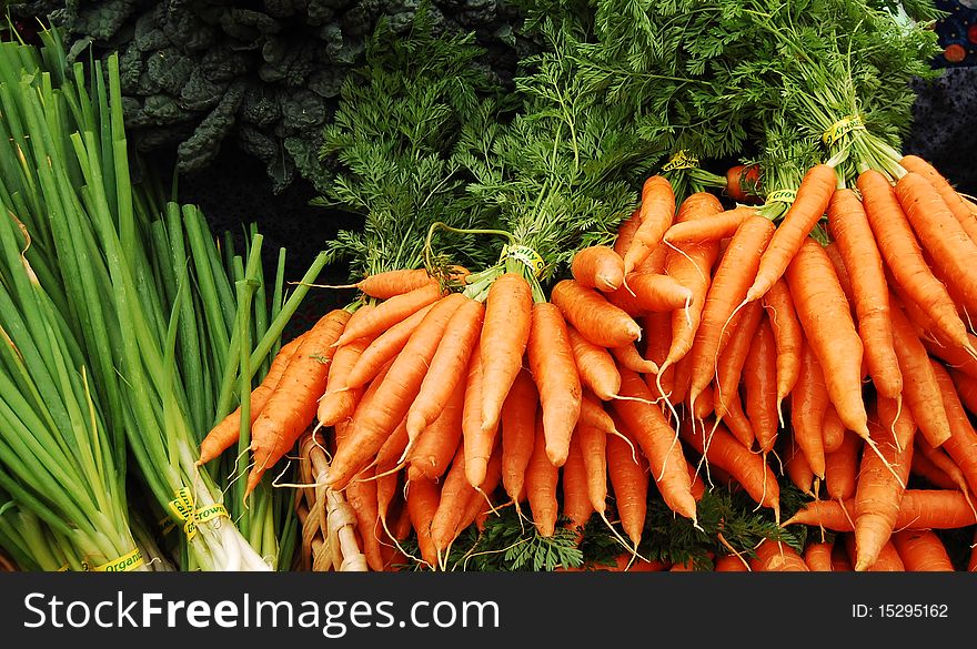 Bunches of carrots and green onions at farmer's market in portland, oregon