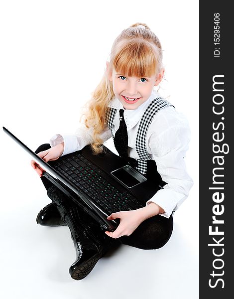 Shot of a little girl sitting on a floor with her laptop. Isolated over white background. Shot of a little girl sitting on a floor with her laptop. Isolated over white background.