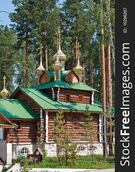 Wooden orthodox church among the pine trees in Russia, Urals. Wooden orthodox church among the pine trees in Russia, Urals