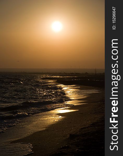 Bright sea sunset above the beach