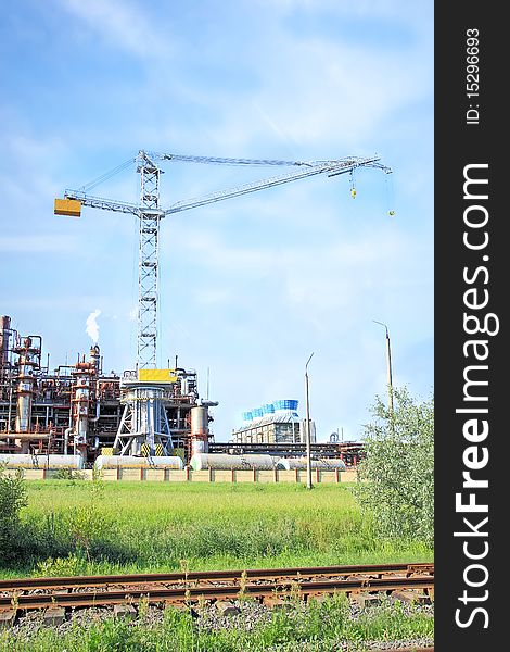 Factory on manufacture of nitric fertilizers with the elevating crane, represented against the blue sky. Factory on manufacture of nitric fertilizers with the elevating crane, represented against the blue sky