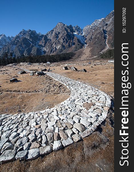 A rocky mountain path leading to some hills in Yamthung Valley, in Sikkim, India.