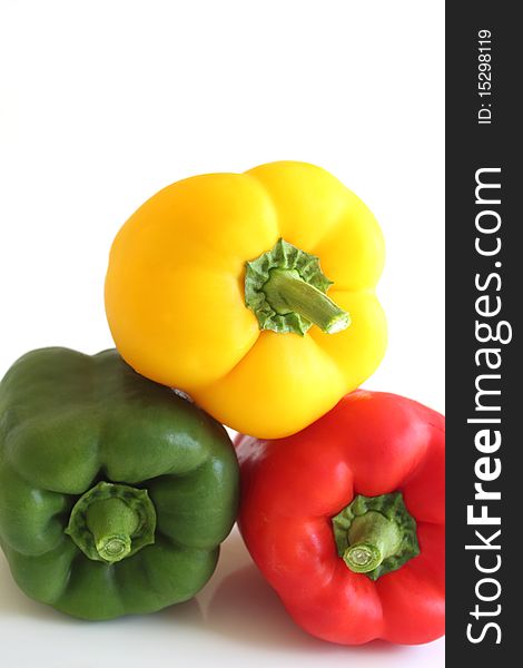 Three colorful peppers isolated on white background. Three colorful peppers isolated on white background.