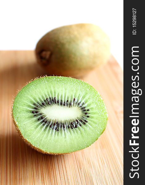 Kiwis on wooden cutting board. Kiwis on wooden cutting board.