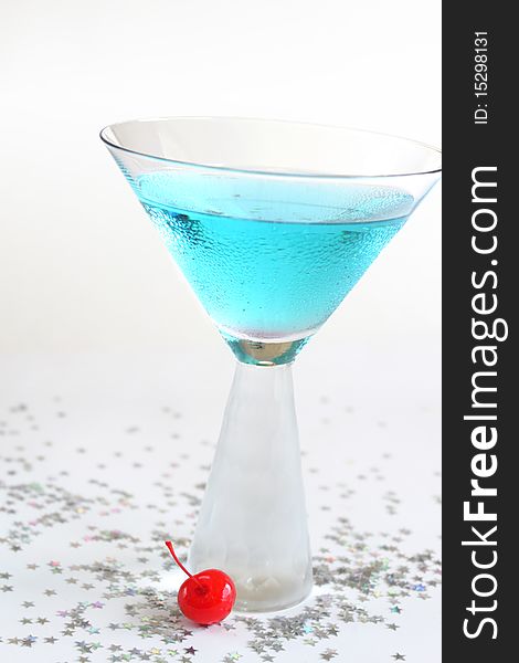 Closeup of sparkling blue drink with cherry.