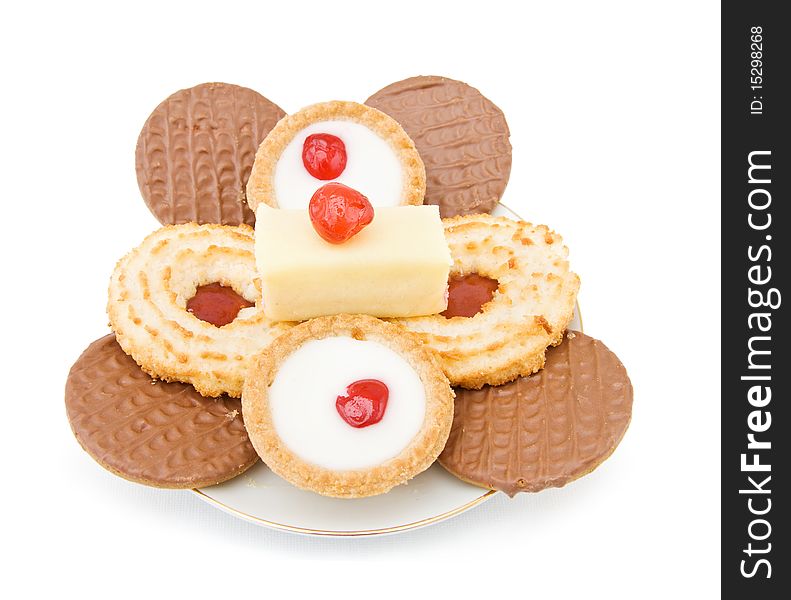 Assorted mix of sweets and cookies with chocolate and jam biscuits, cupcakes and cookies with cherry on top. Isolated over white background. Assorted mix of sweets and cookies with chocolate and jam biscuits, cupcakes and cookies with cherry on top. Isolated over white background.