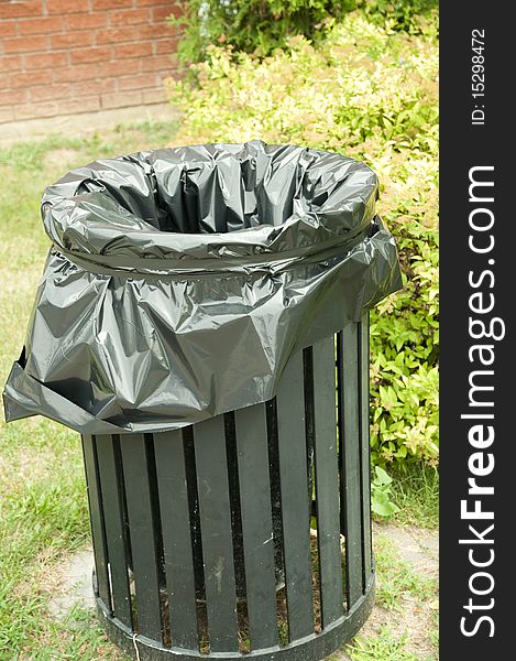 Black garbage bin with plastic liner