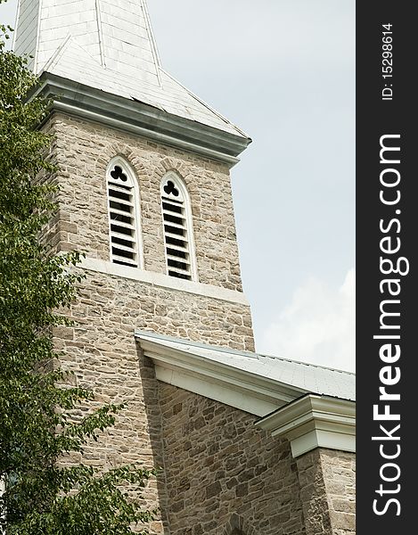 Historic church bell tower with midday shadows