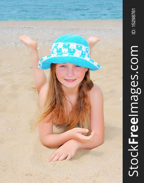 The little girl in hat on the beach. The little girl in hat on the beach