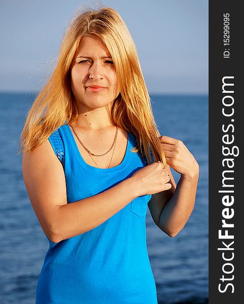 The beautiful girl standing by the ocean in the morning. The beautiful girl standing by the ocean in the morning