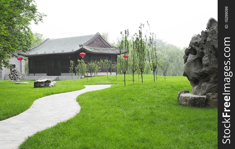 Garden With Green Meadow And Ancient Building