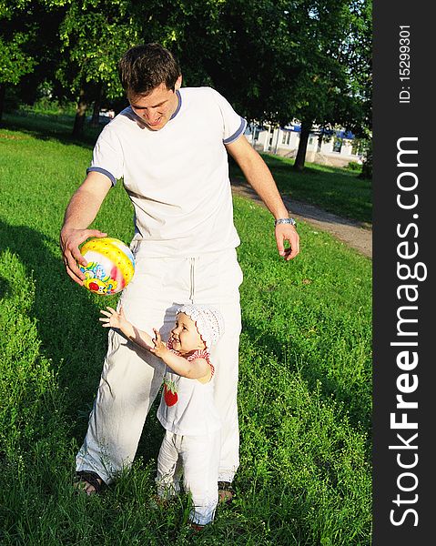 Father and daughter playing at the park.