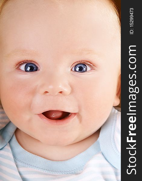 Portrait of happy smiling baby with blue eyes, studio shot. Portrait of happy smiling baby with blue eyes, studio shot