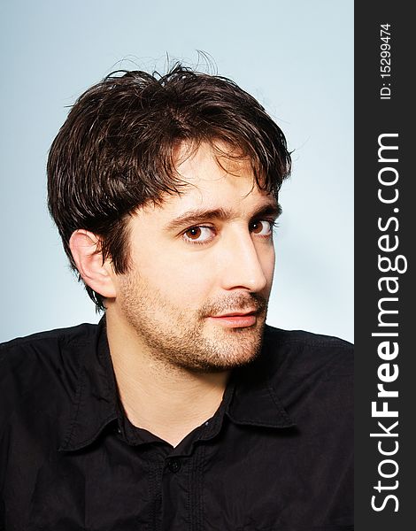 Portrait of young attractive dark-haired smiling man, studio shot. Portrait of young attractive dark-haired smiling man, studio shot