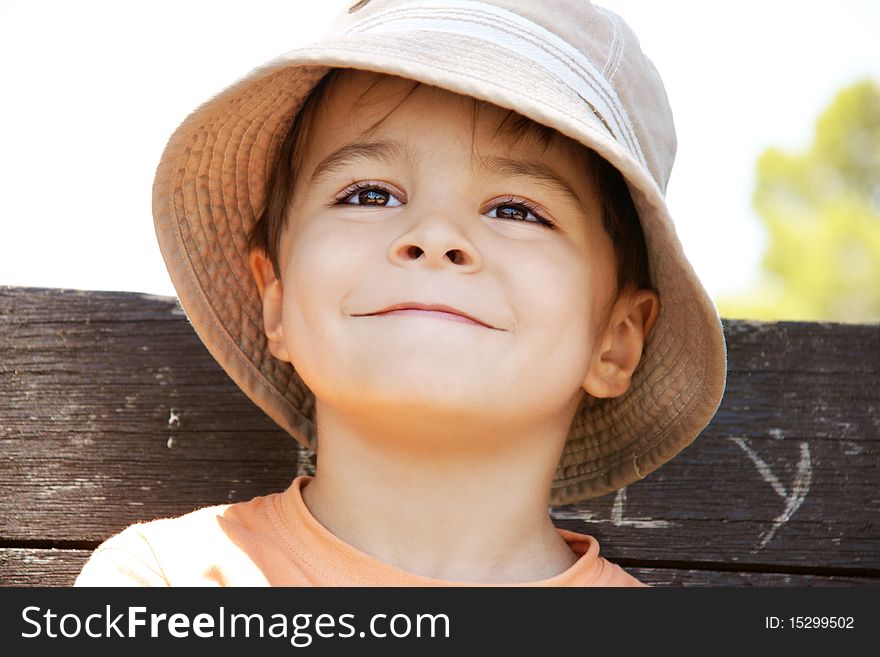 Portrait of pleased smiling little boy in hat, outdoor shot. Portrait of pleased smiling little boy in hat, outdoor shot