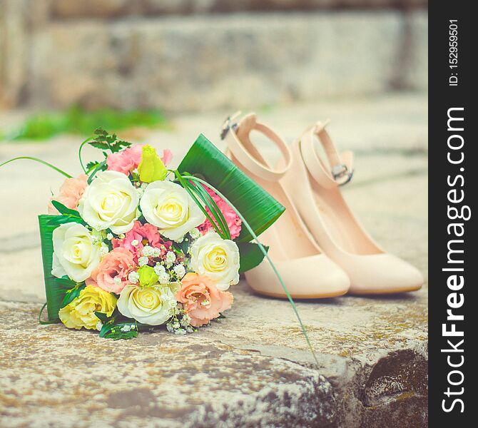 Bridal bouquet and shoes. Beautiful wedding decoration. Bride accessories. Wedding and marriage