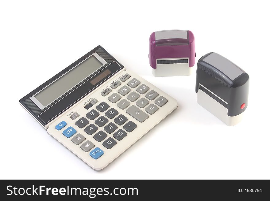 Financial calculator and two stamps photographed on white background