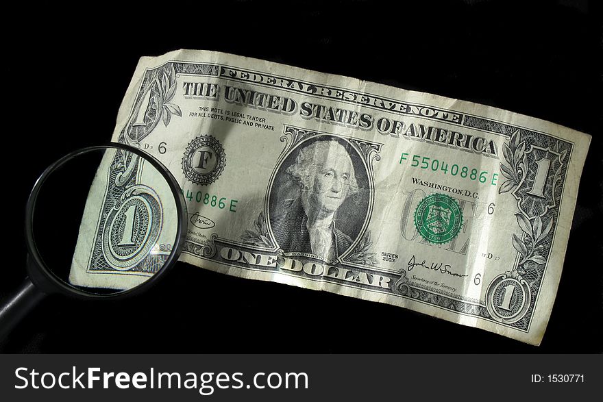 Magnifying glass over one dollar bill. Magnifying glass over one dollar bill